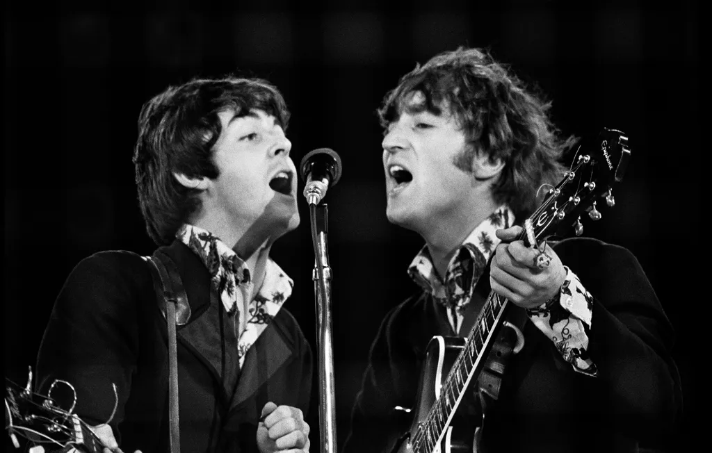 A photo of Paul & John singings and playing.